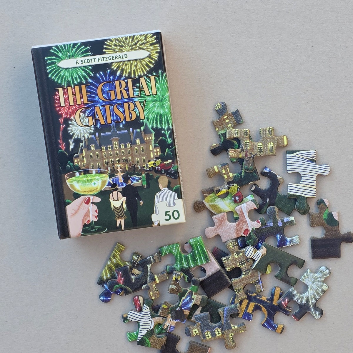 Book titled 'The Great Gatsby' with a partially completed puzzle on a light grey background