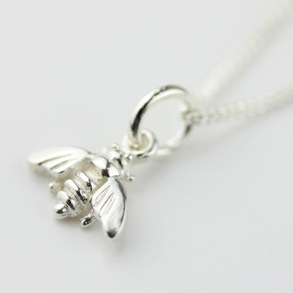 Silver bee charm on a white background
