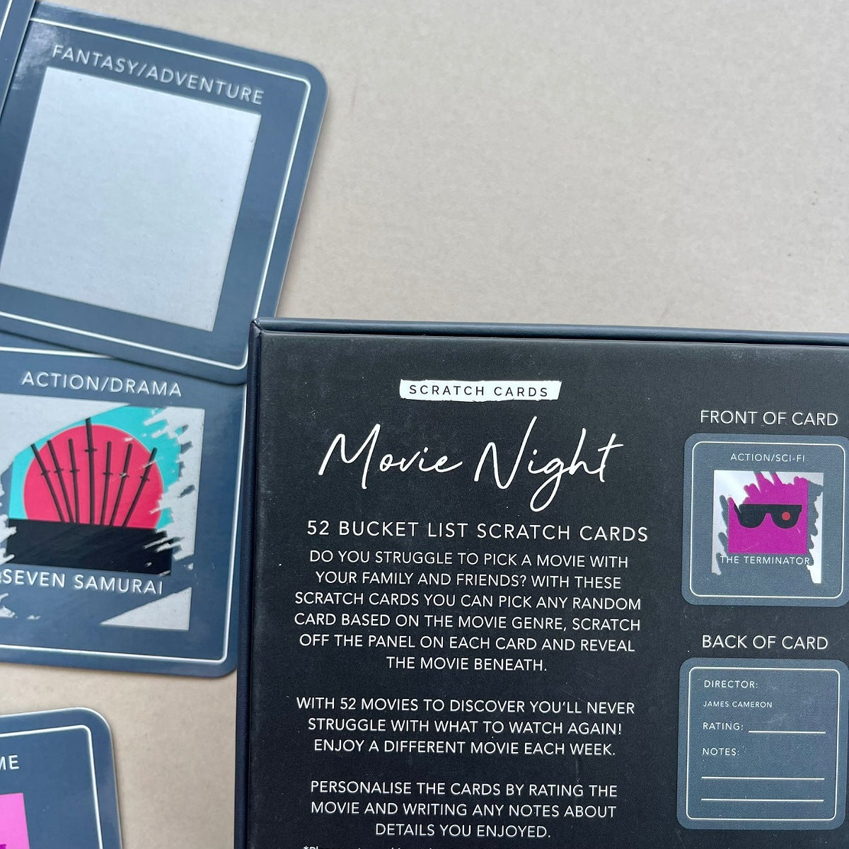 Movie Night scratch cards with a grey box packaging on a beige surface