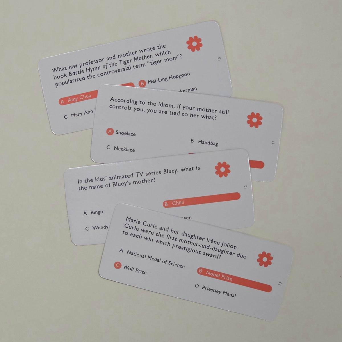 Educational card game questions on a light grey background