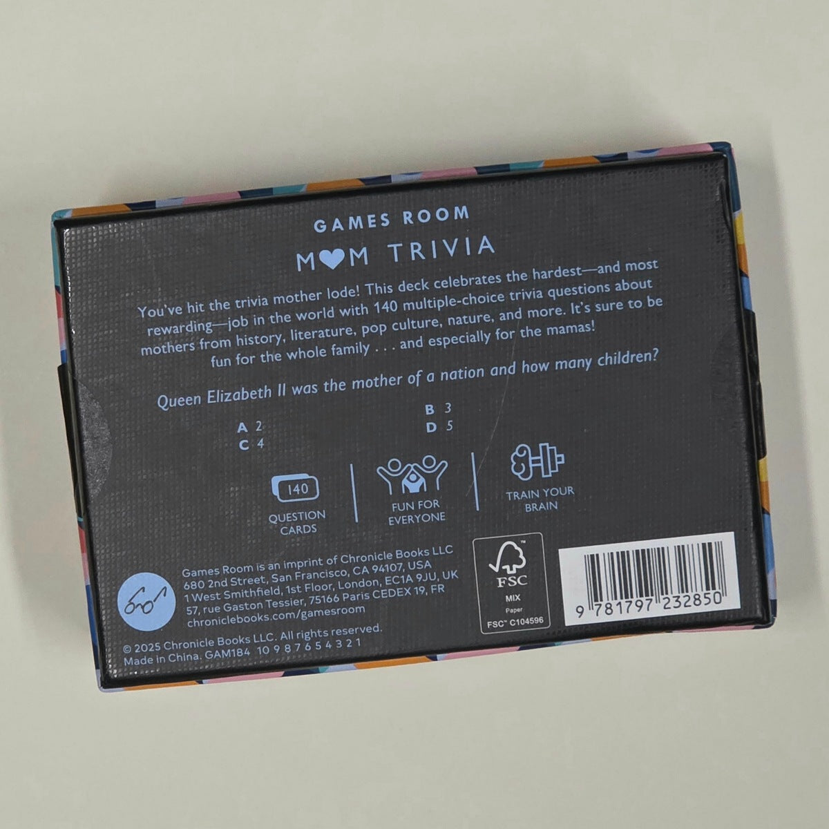 Back of a card game box with text and branding on a light grey background
