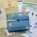 Blue 'Death in Antarctica' mystery party case with investigation and crime files on a table.
