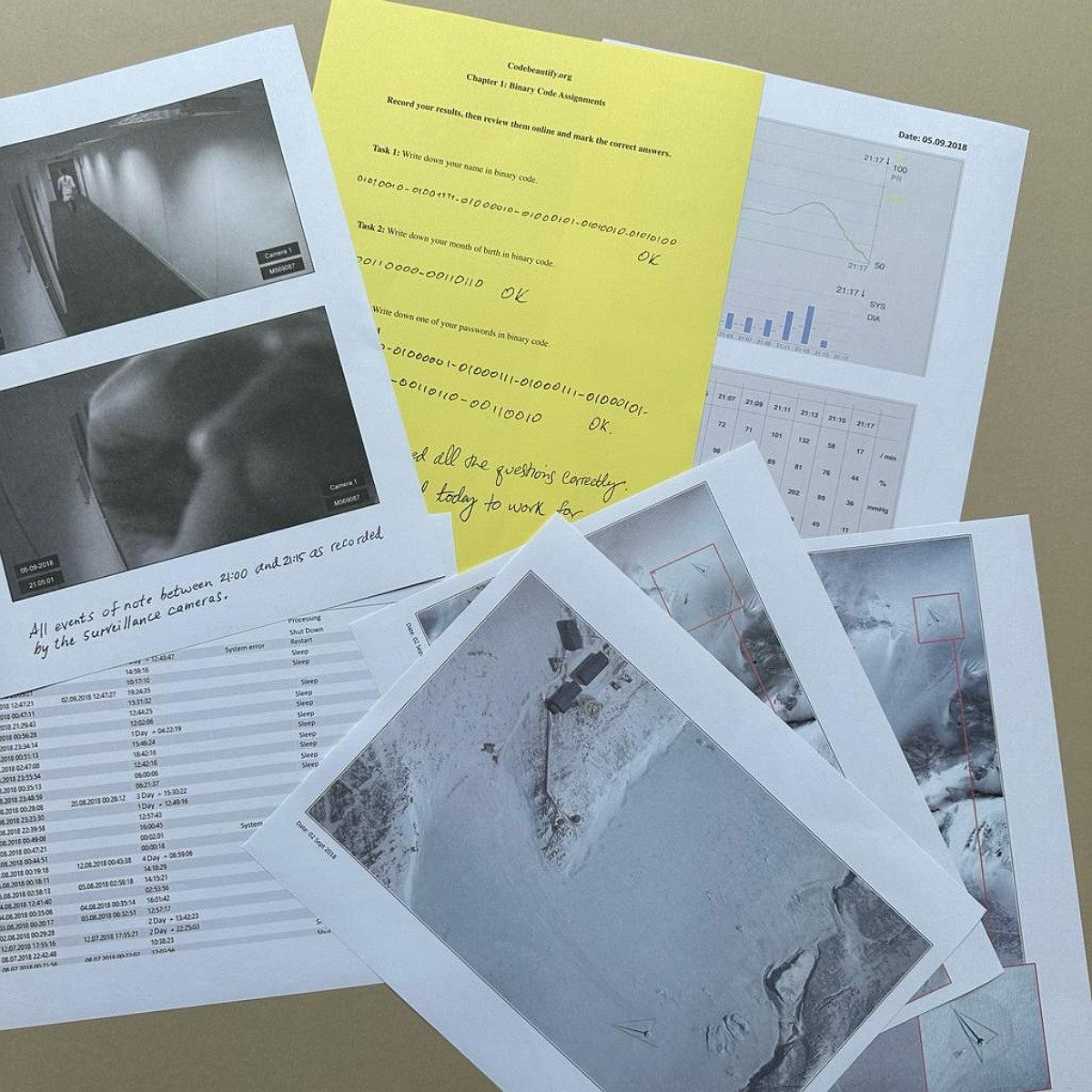 Collection of printed documents and photographs on a flat surface