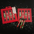 Set of Christmas-themed crackers with nutcracker design on a black background with white dots.