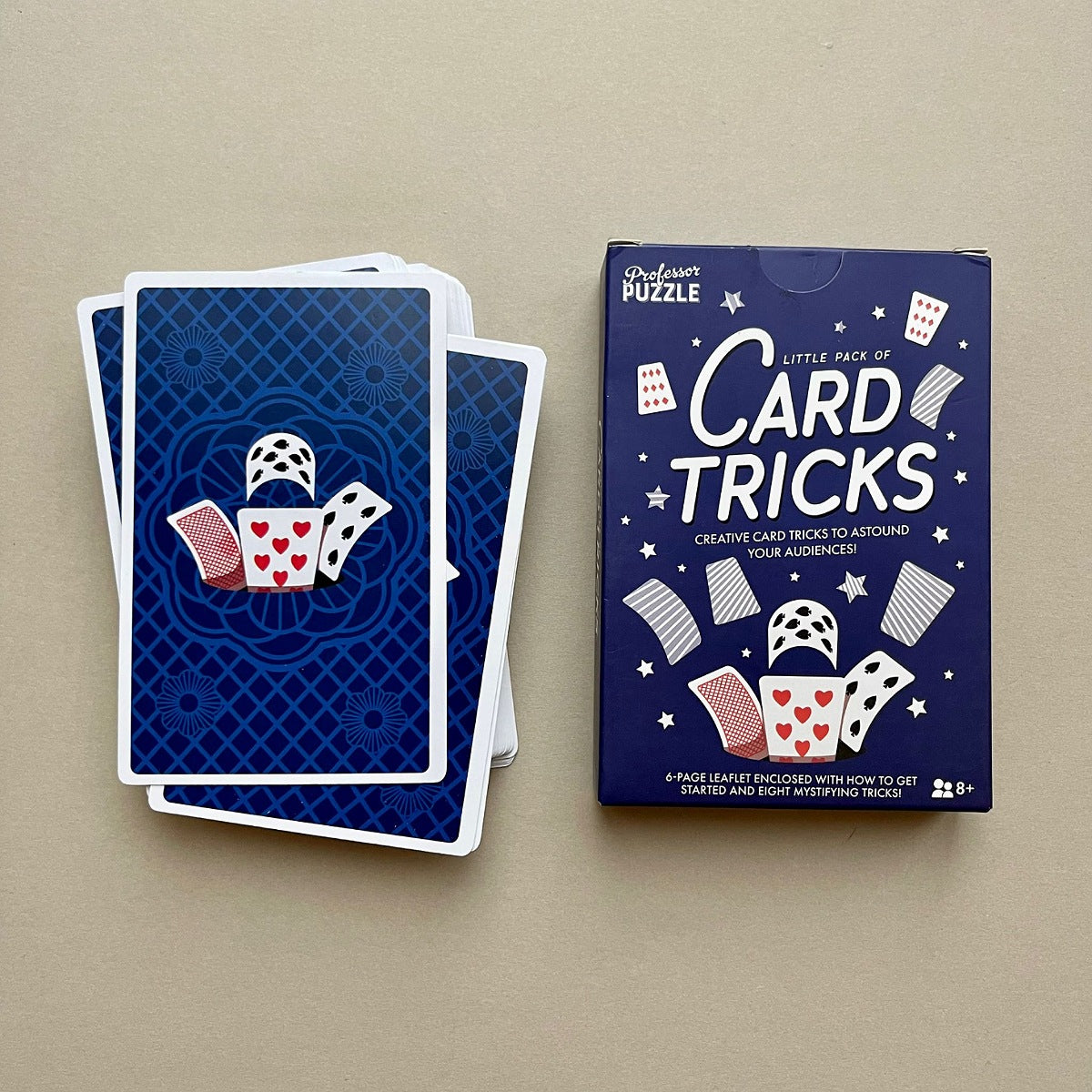 Blue box labeled 'Little Book of Card Tricks' on a beige background