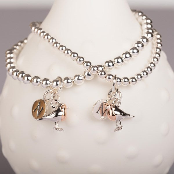 Silver beaded bracelet with robin charms on a mannequin wrist