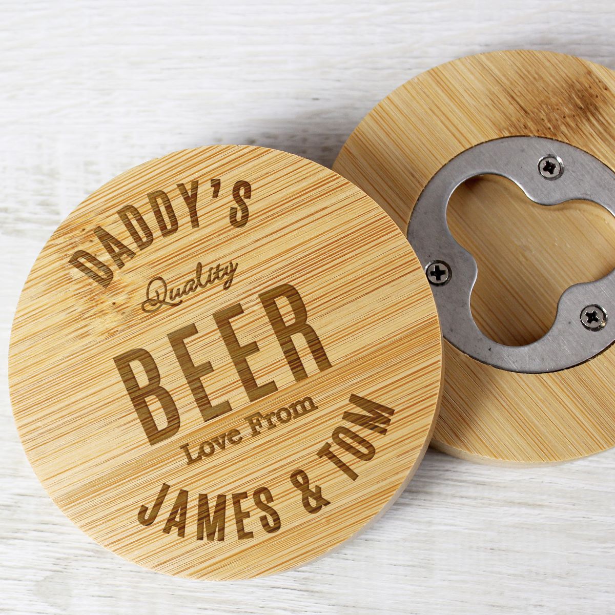 Wooden coaster with bottle opener and engraved text on a light wooden surface