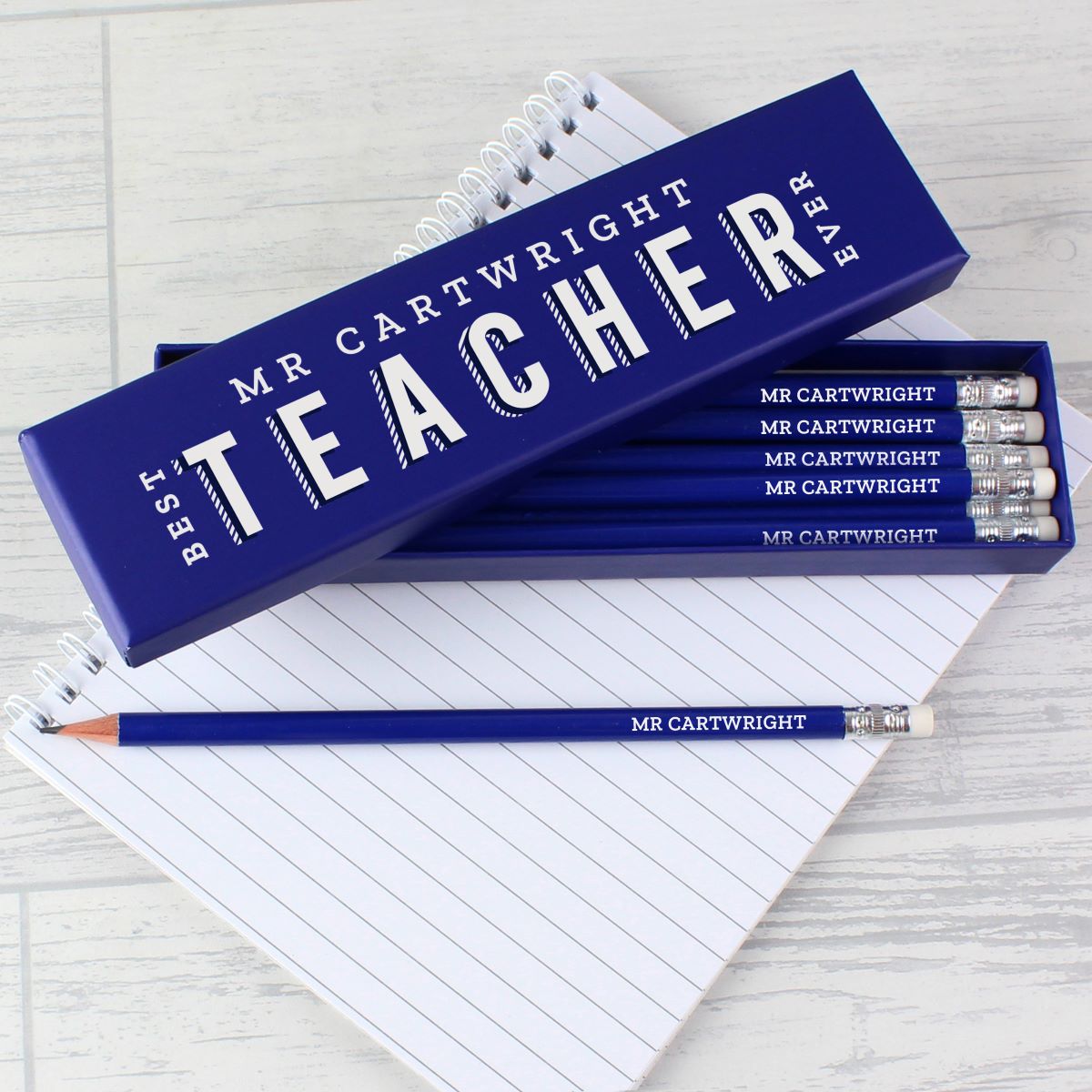 Pencil set with personalized packaging on a notebook