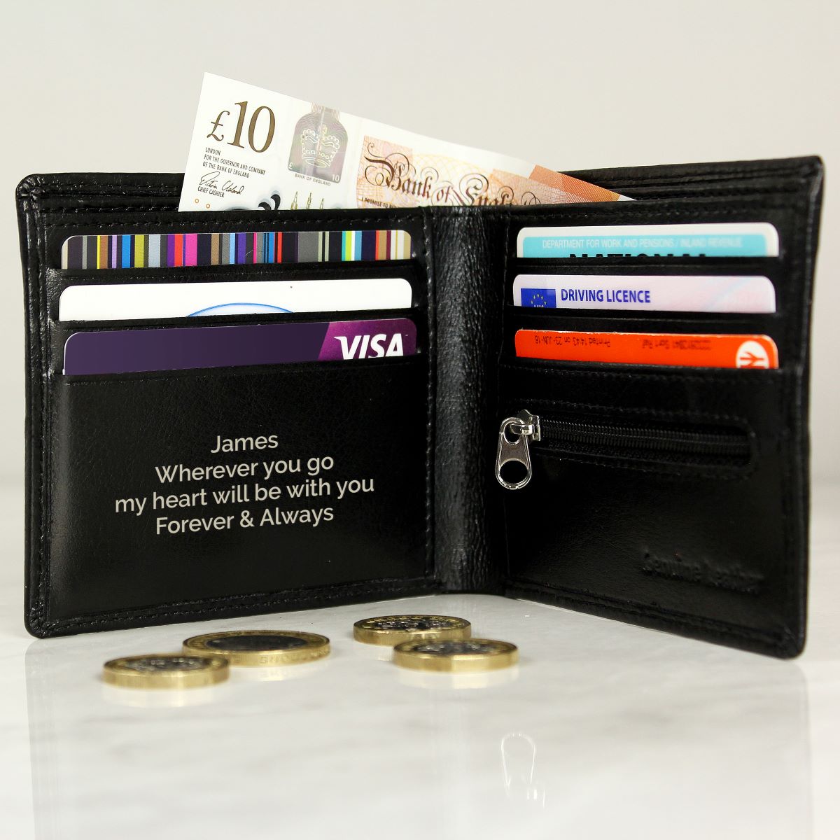 Black wallet with cards and coins on a white background