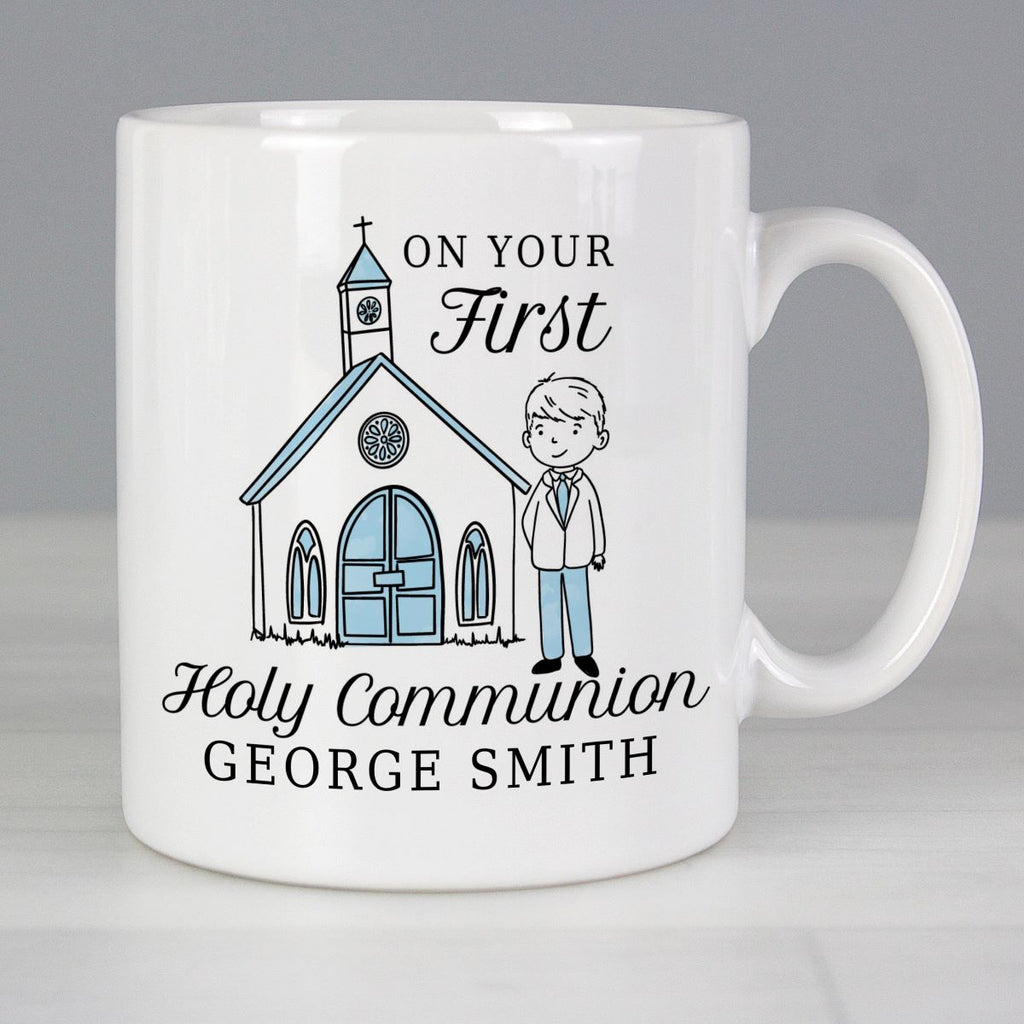White mug with a design of a church and a boy, and text 'On Your First Holy Communion George Smith' on a gray background.