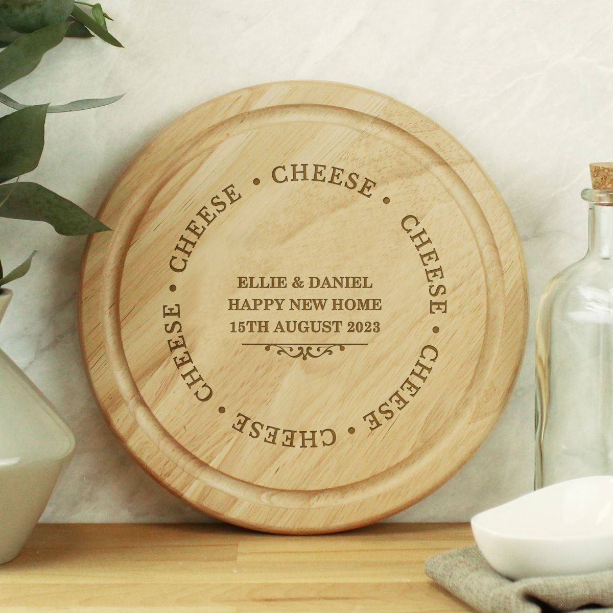 Wooden cheese board with engraved text on a kitchen counter