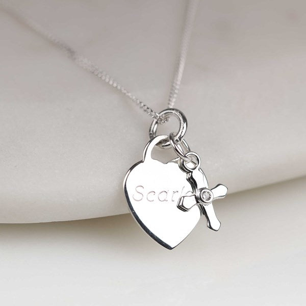 Silver necklace with heart-shaped pendant and 'Scarlet' engraving on a light background