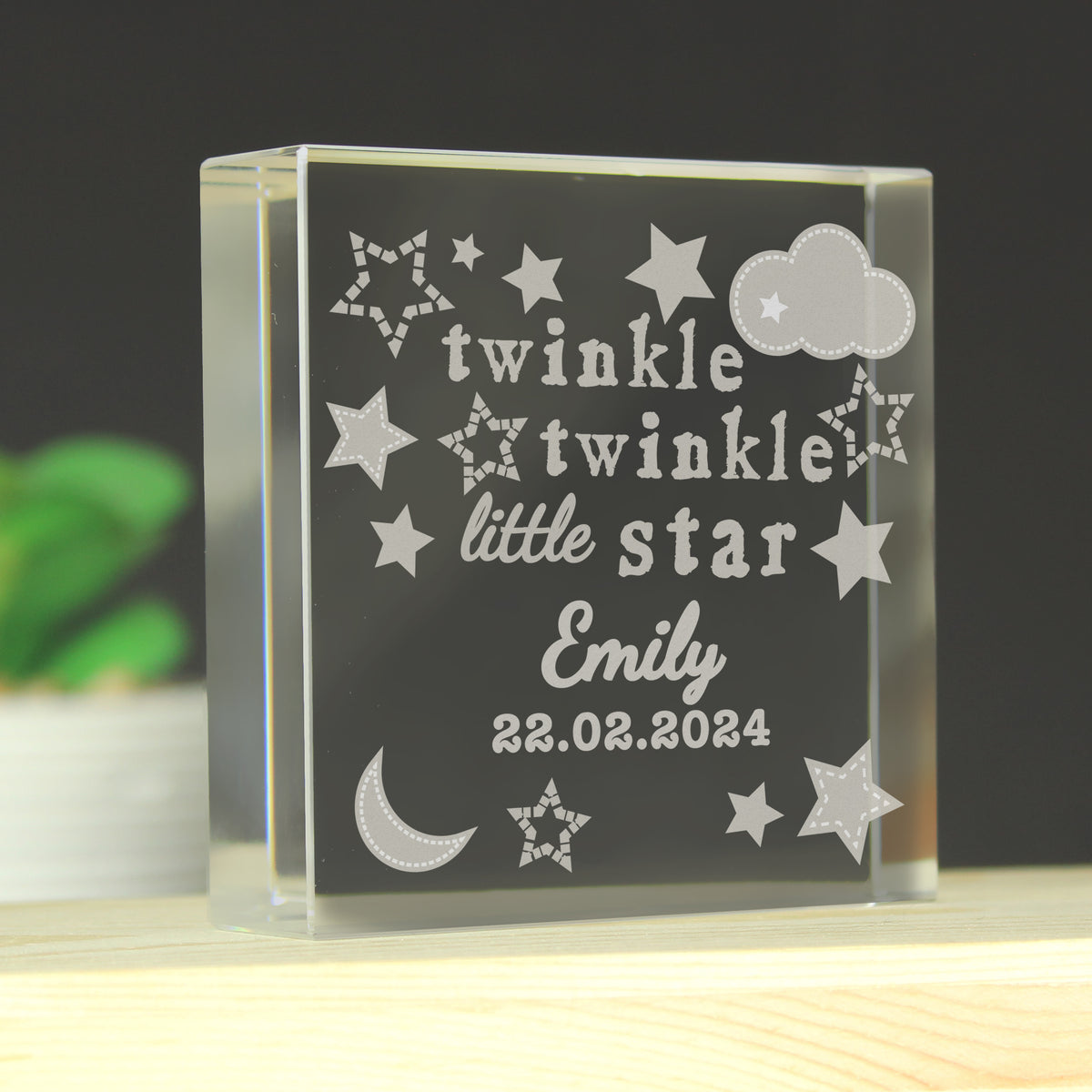 Glass block with engraved text 'twinkle twinkle little star Emily 22.02.2024' on a dark background