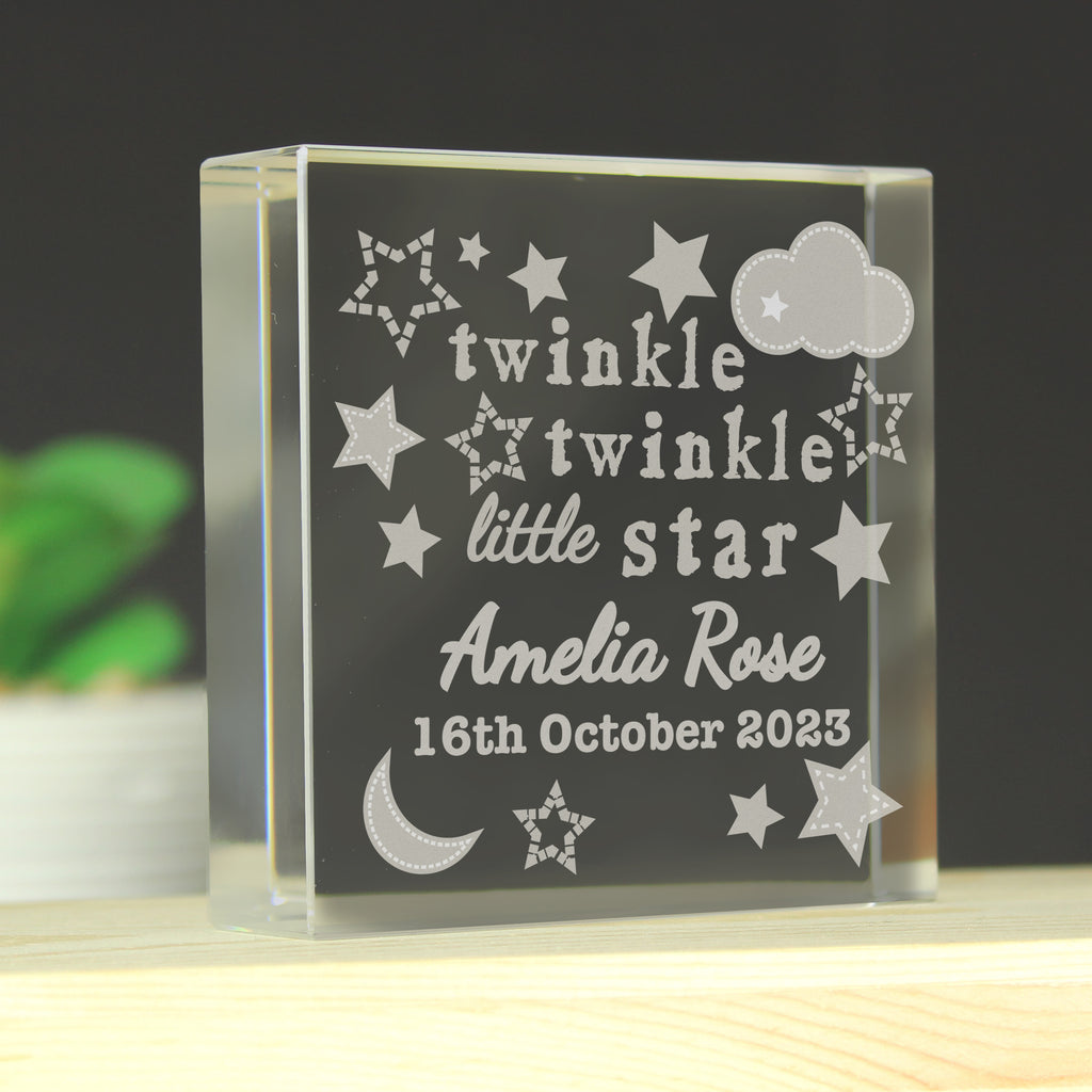 Glass block with engraved text 'twinkle twinkle little star Amelia Rose 16th October 2023' on a dark background.