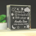 Glass block with engraved text 'twinkle twinkle little star Amelia Rose 16th October 2023' on a dark background.
