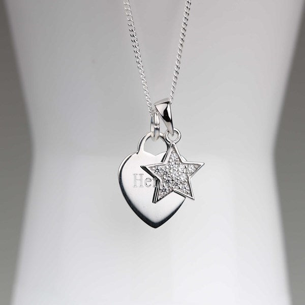 A silver heart and star pendant necklace displayed on a white mannequin bust. The heart pendant features the engraved name 'Henry', and the star is adorned with small clear crystals.
