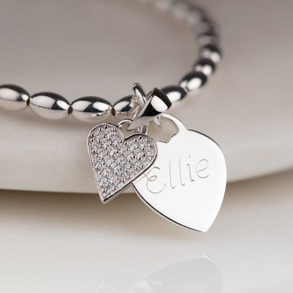 Silver bracelet with heart-shaped charms on a white background