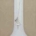 A silver ballerina pendant necklace with a letter charm, displayed on a white jewelry bust against a beige background.