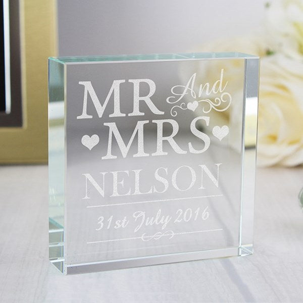 Glass block with engraved 'MR AND MRS NELSON' and date on a light background