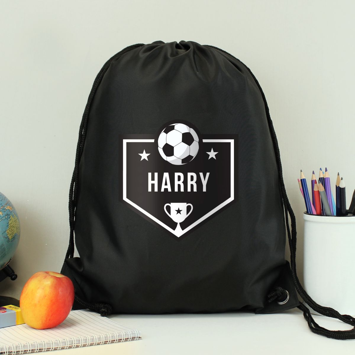 Black drawstring bag with 'Harry' and sports-themed design on a white surface.