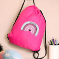 Pink drawstring bag with rainbow design and 'Evelyn' text on a beige background