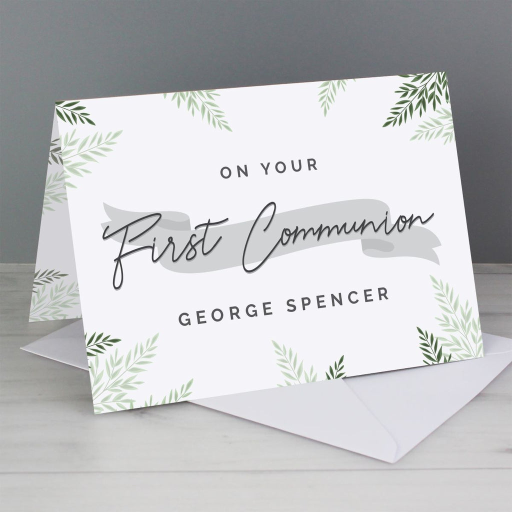 Greeting card with 'On Your First Communion' text and green leaf patterns on a gray background