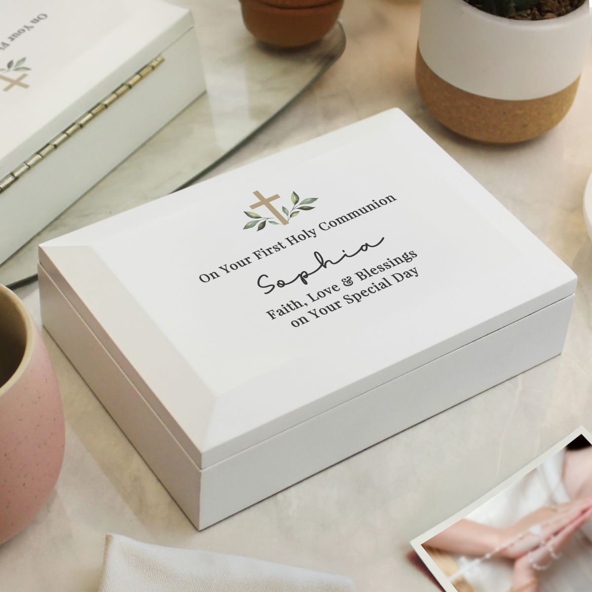 Personalized white box with engraved text on a light surface