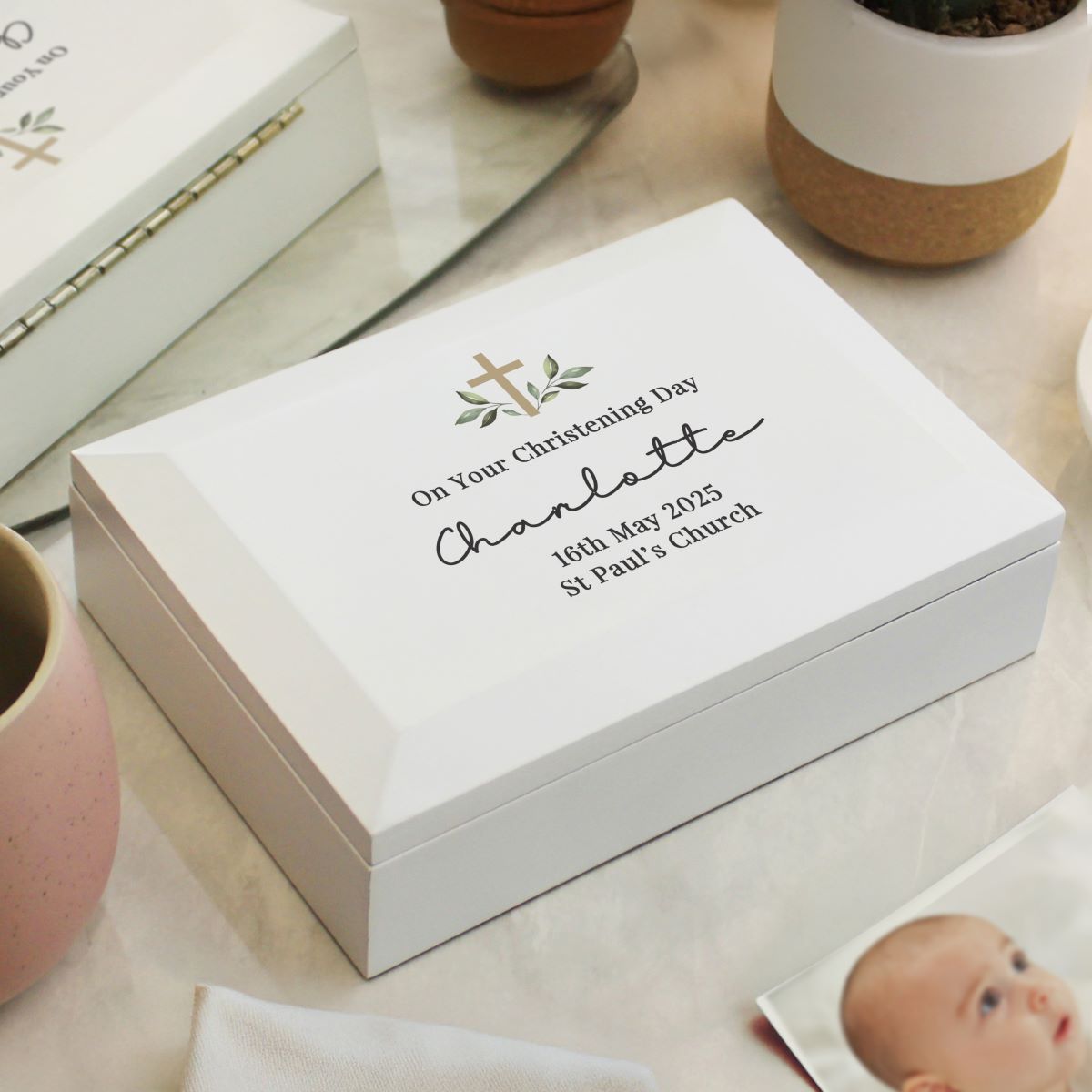 White keepsake box with personalized text on a light surface