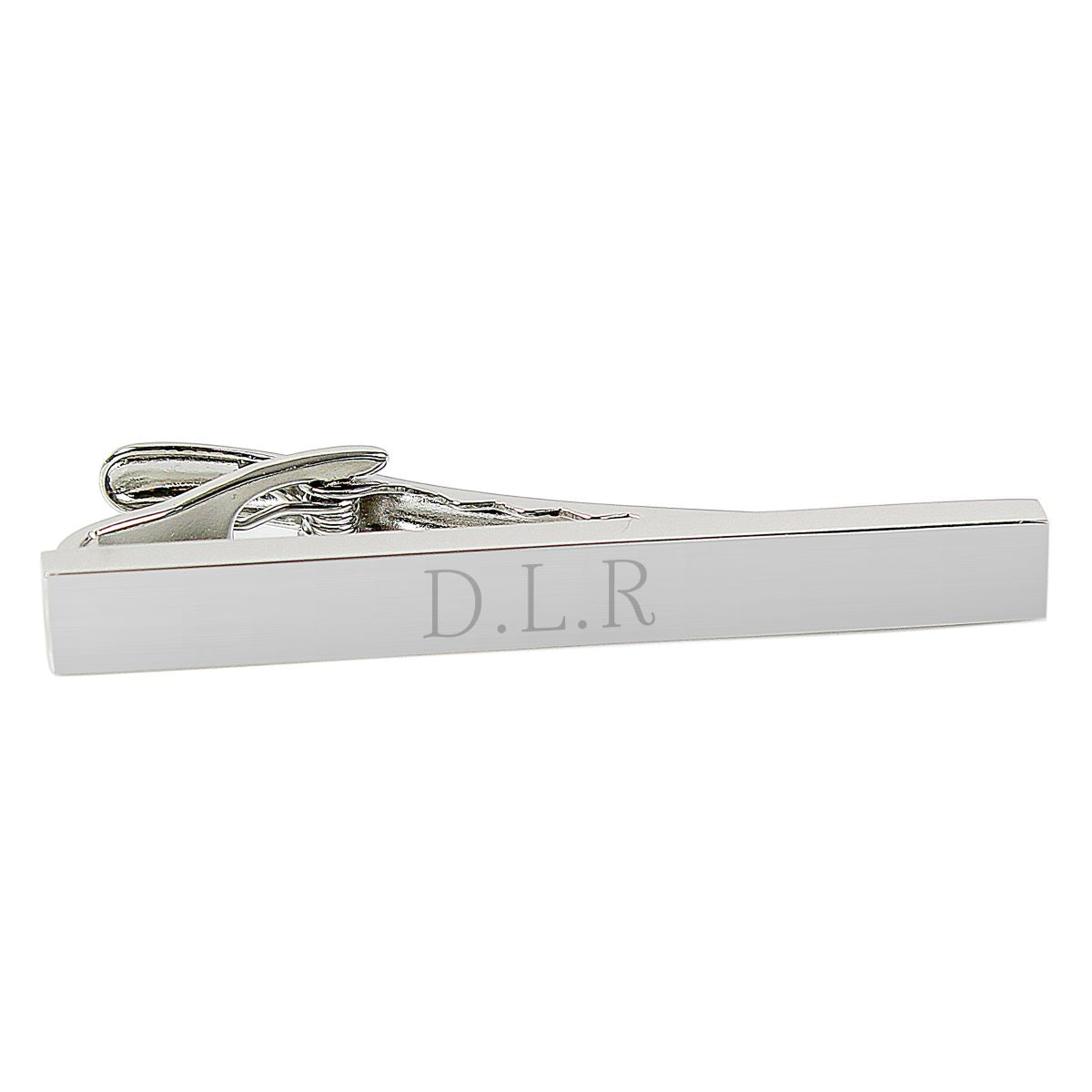 Silver tie clip with letters engraved.