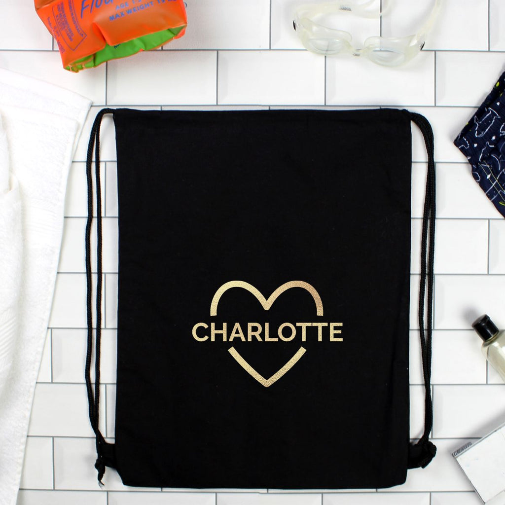 Black drawstring bag with 'SOPHIE' in a heart shape on a tiled floor.