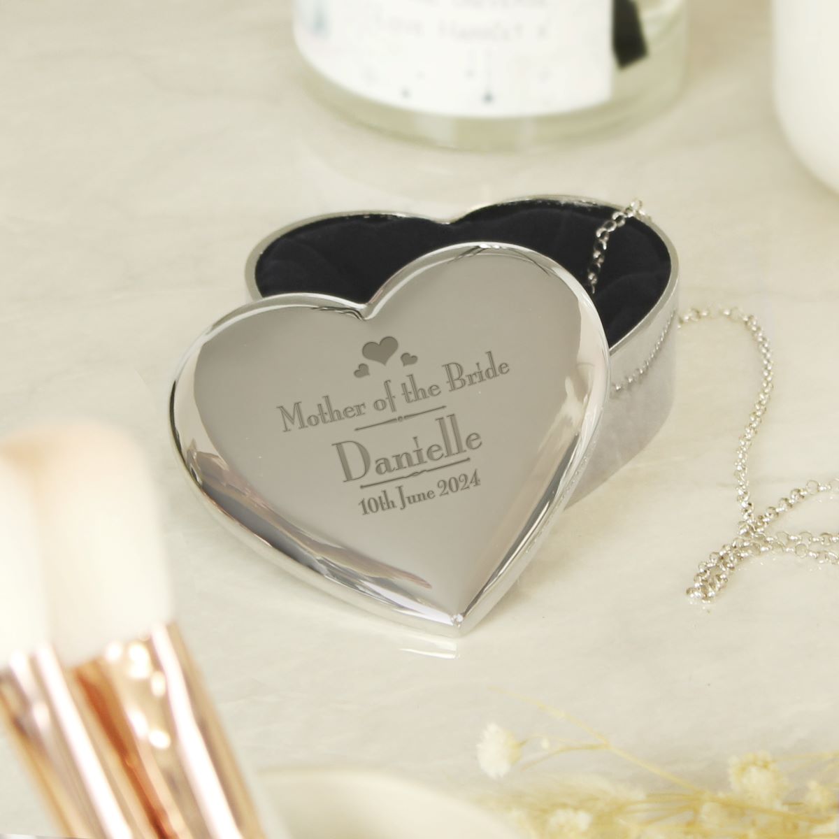 Heart-shaped silver box engraved with 'Mother of the Bride' on a light background.
