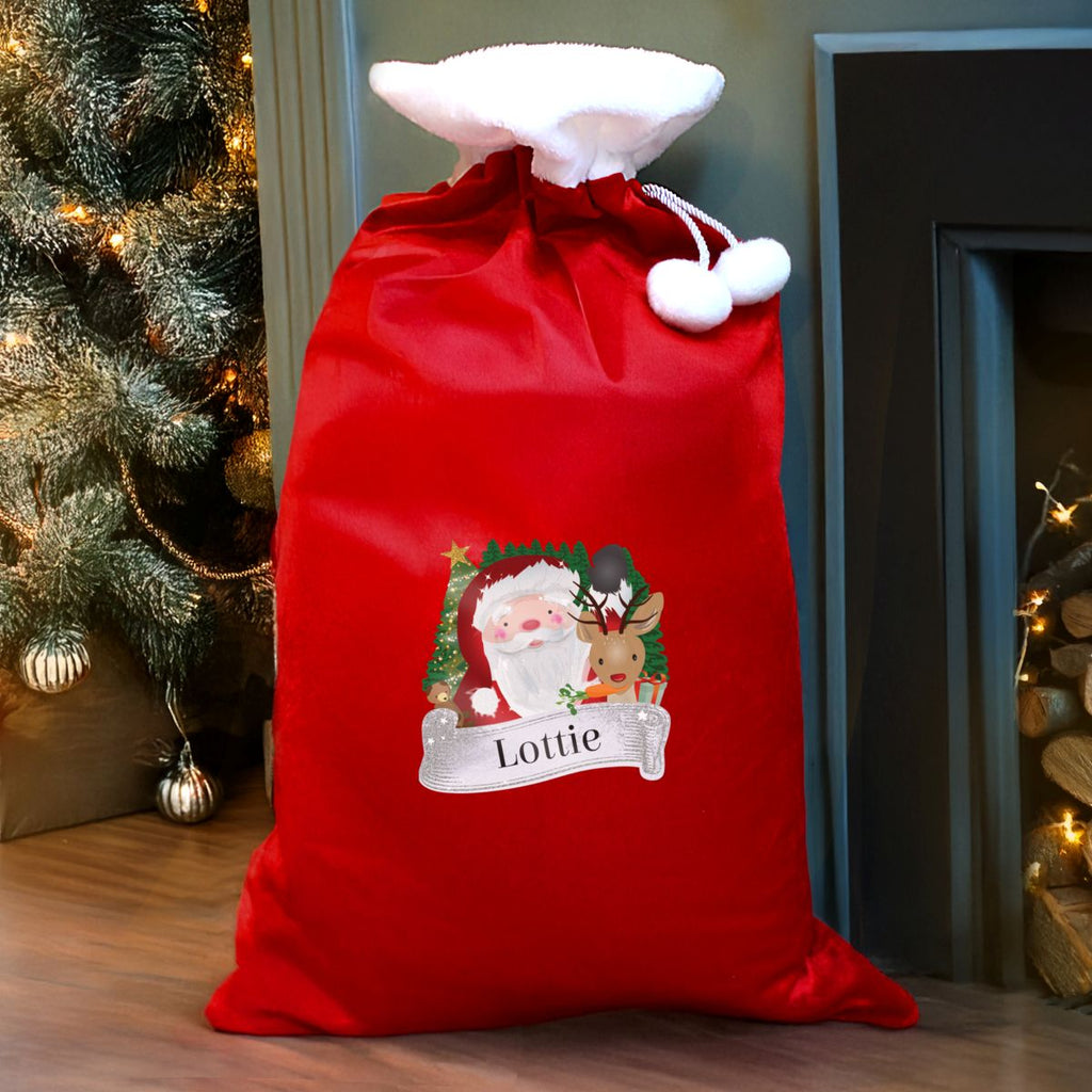 Red Christmas sack with Santa and reindeer design, personalized with 'Lottie', in front of a decorated Christmas tree and fireplace.