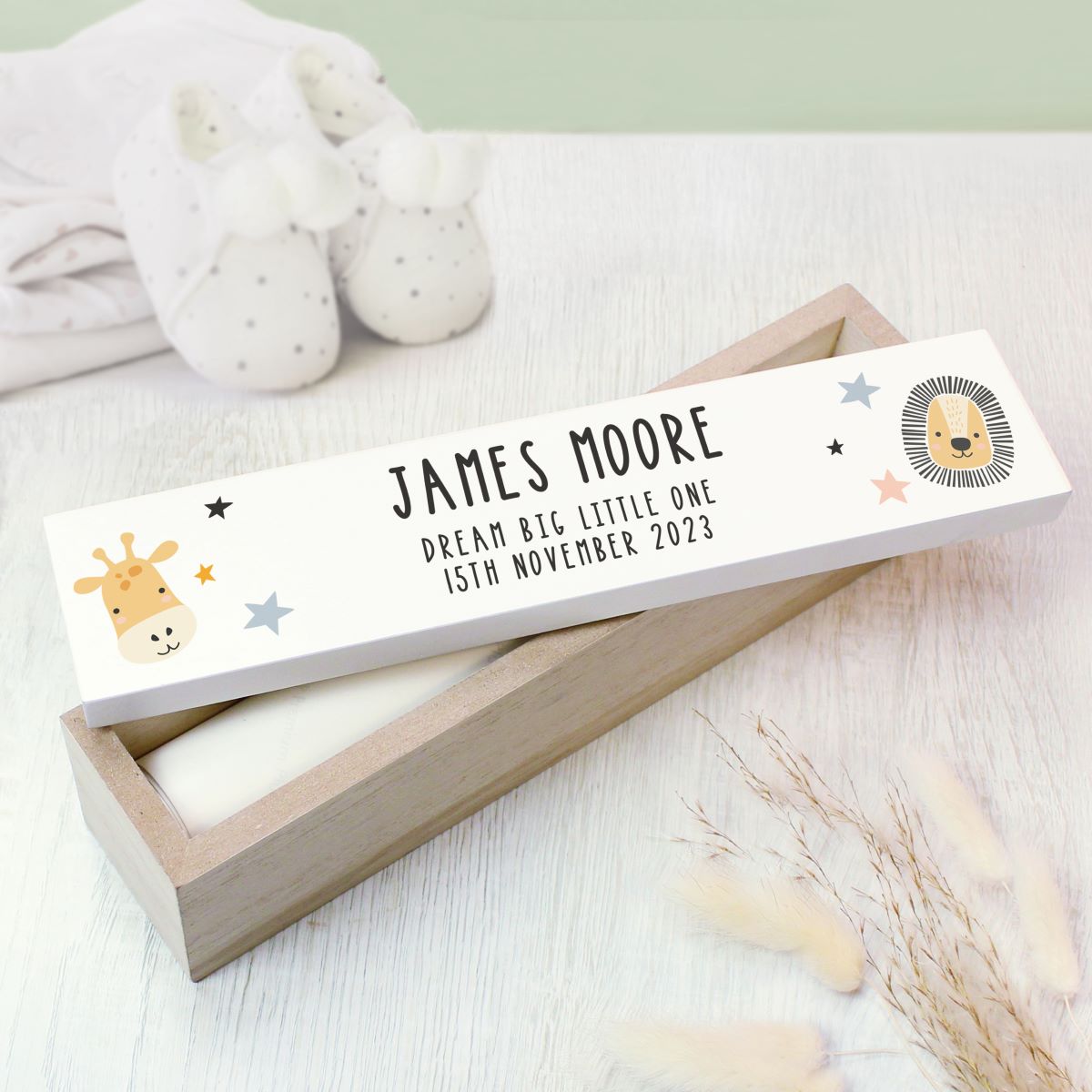 Personalized baby certificate box with name and date on a white background