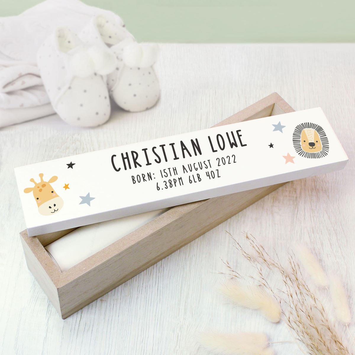 Wooden certificate holder with cartoon animals and text in a wooden box on a light surface.