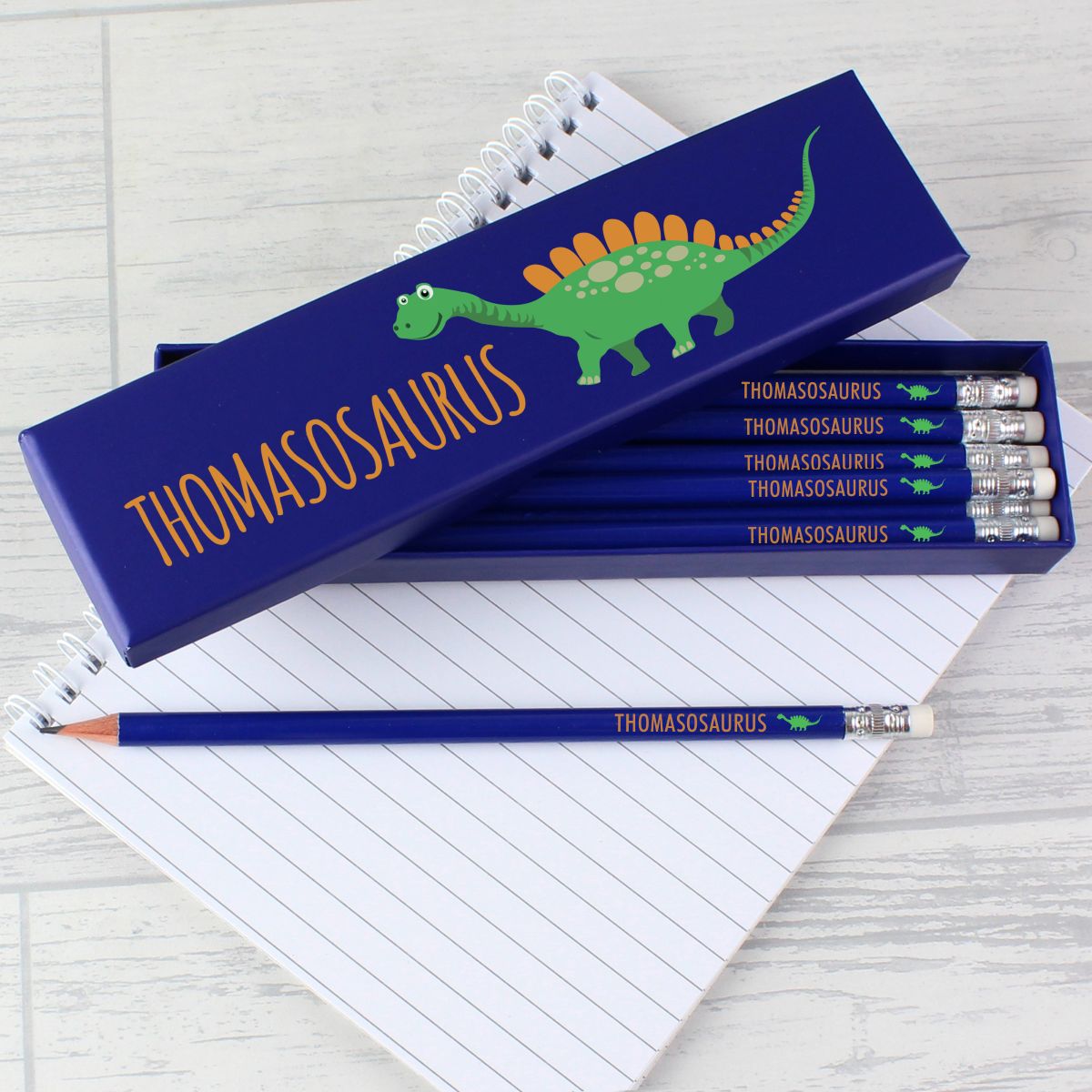 Pencil set with 'Alexosaurus' design on a notebook