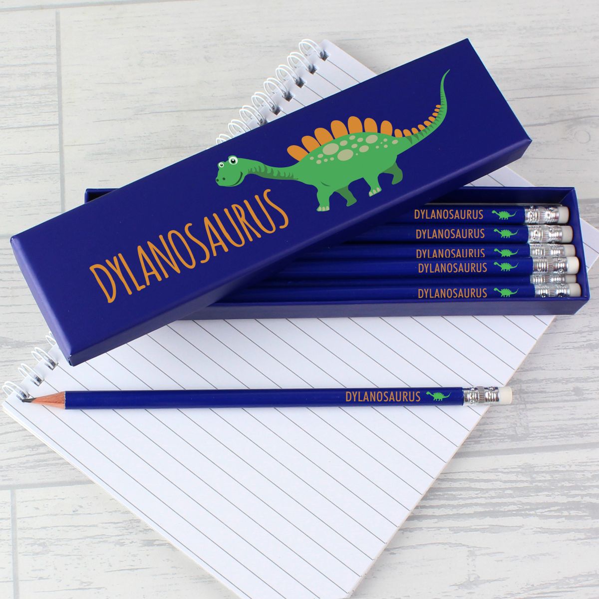 Pencil set with 'Alexosaurus' design on a notebook