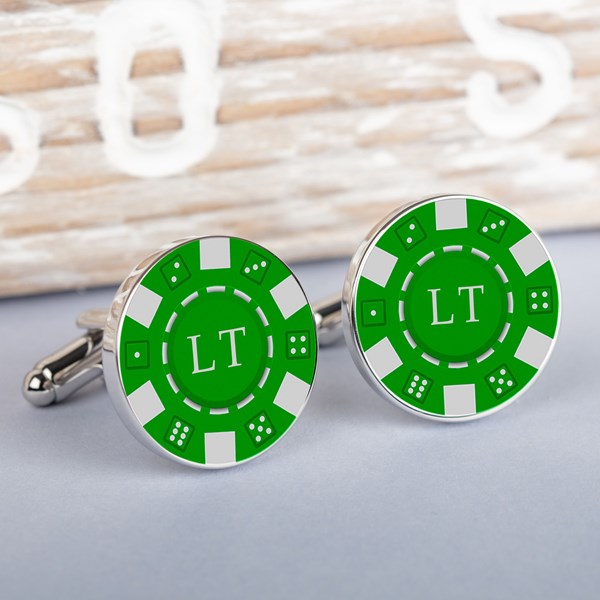A pair of round silver-toned cufflinks styled like green and white casino chips. Each one has a green center white border segments, and the initials 'LT' in white.