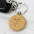 Wooden keychain with 'Harriet's Home Sweet Home' engraving on a white background