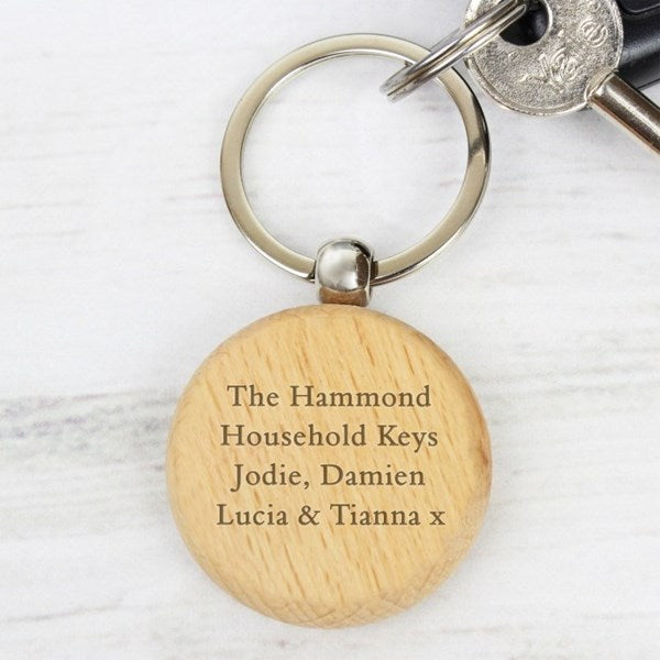 Wooden keychain with engraved text on a white background