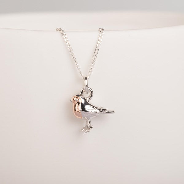 A silver bird pendant necklace on a delicate silver chain, displayed against a clean white background.