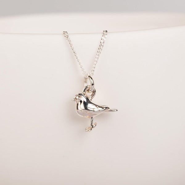 A silver bird pendant necklace on a delicate silver chain, displayed against a clean white background.