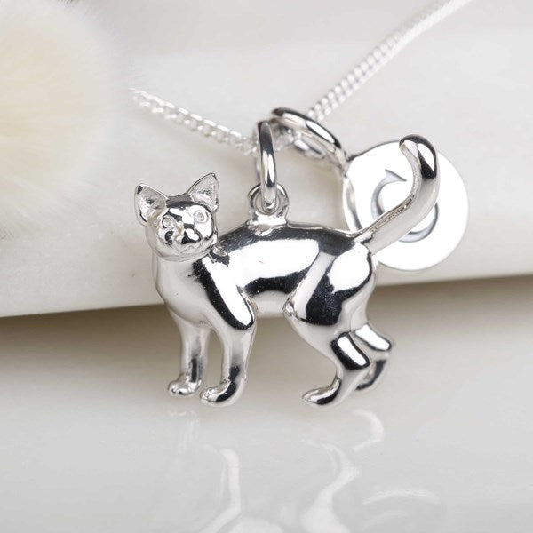 A polished silver cat pendant necklace on a matching silver chain, displayed against a soft white background.