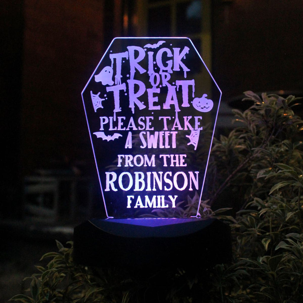 Decorative Halloween sign with personalized text on a dark background