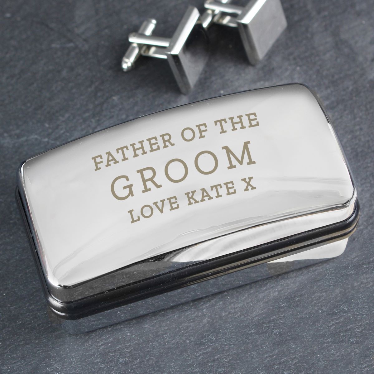 Silver box with engraved text 'Father of the Groom Love Kate X' on a dark background