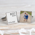 A pair of square silver cufflinks on a whitewashed wooden surface. One cufflink is engraved with the name 'BEST MAN' and the date '20.06.2020 and the other cufflink a personalised image.