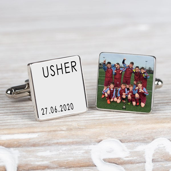 A pair of square silver cufflinks on a whitewashed wooden surface. One cufflink is engraved with the name 'USHER' and the date '27.06.2020 and the other cufflink a personalised image.