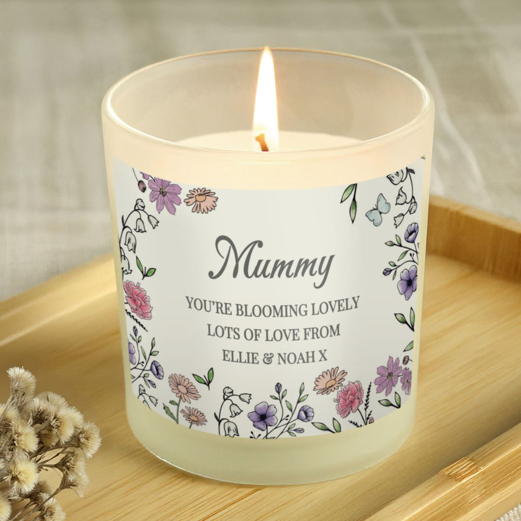 Candle with a decorative label on a wooden surface
