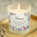 Candle with a decorative label on a wooden surface