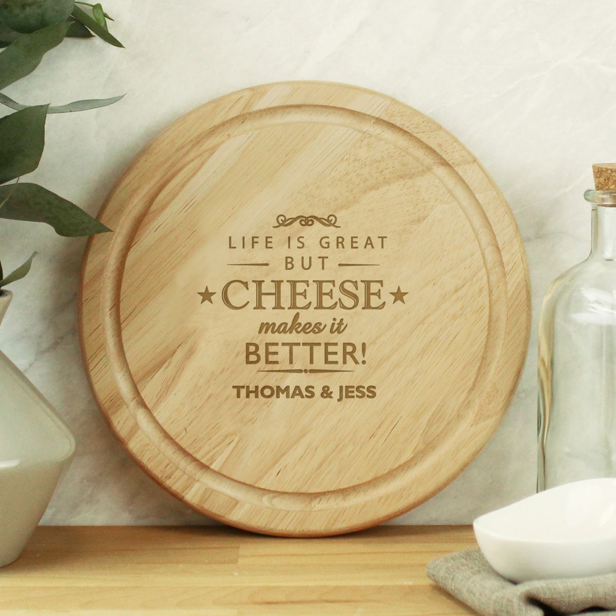 Wooden cutting board with engraved text on a kitchen counter