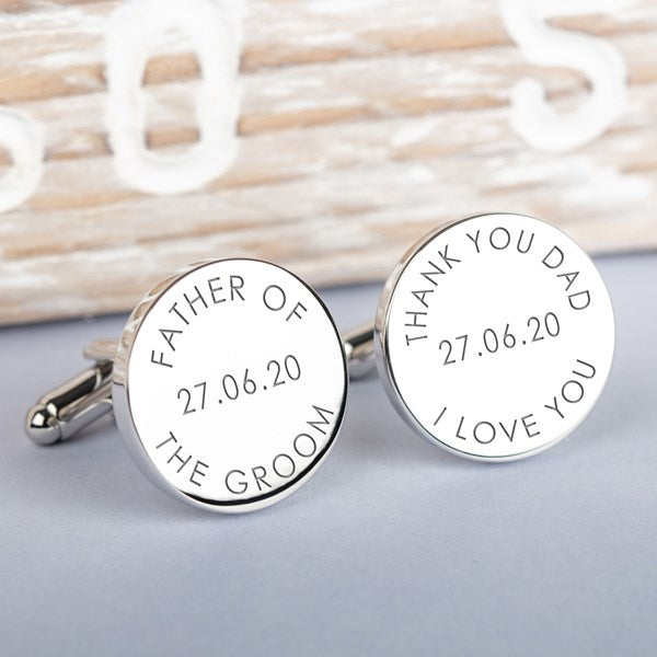 A pair of round silver cufflinks engraved with personalised wedding text, including 'FATHER OF THE GROOM' and 'THANK YOU DAD I LOVE YOU' with a date.